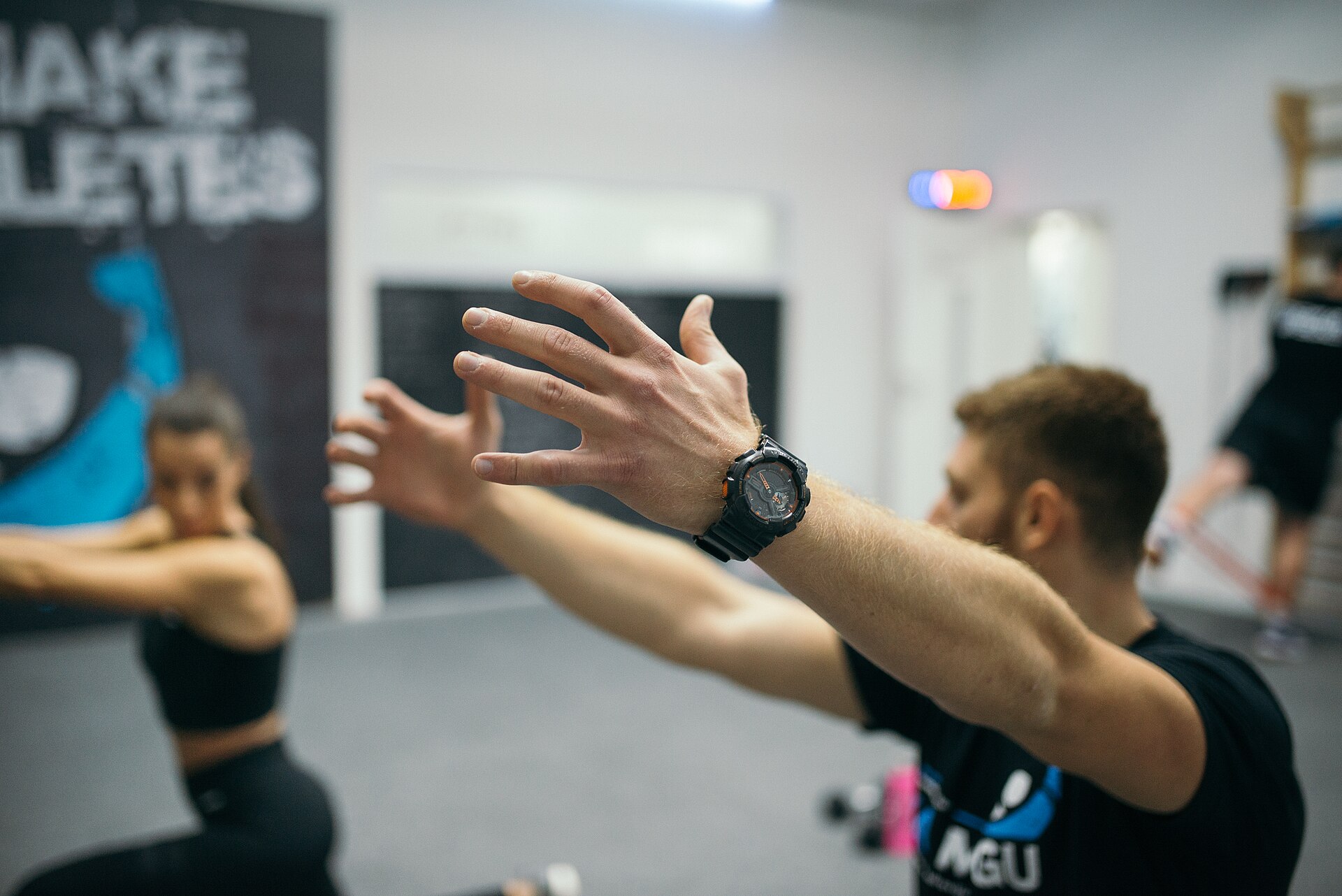A coach demonstrating a movement to a client